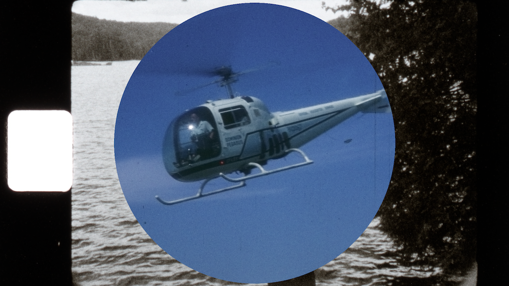 A still from Events in the Tunnel featuring a helicopter layered over top of a peaceful lake scene
