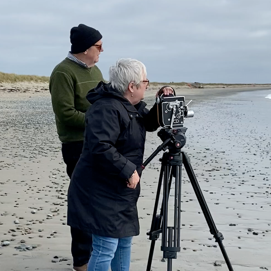 Penny McCann and Eric Walker shooting film on a beach