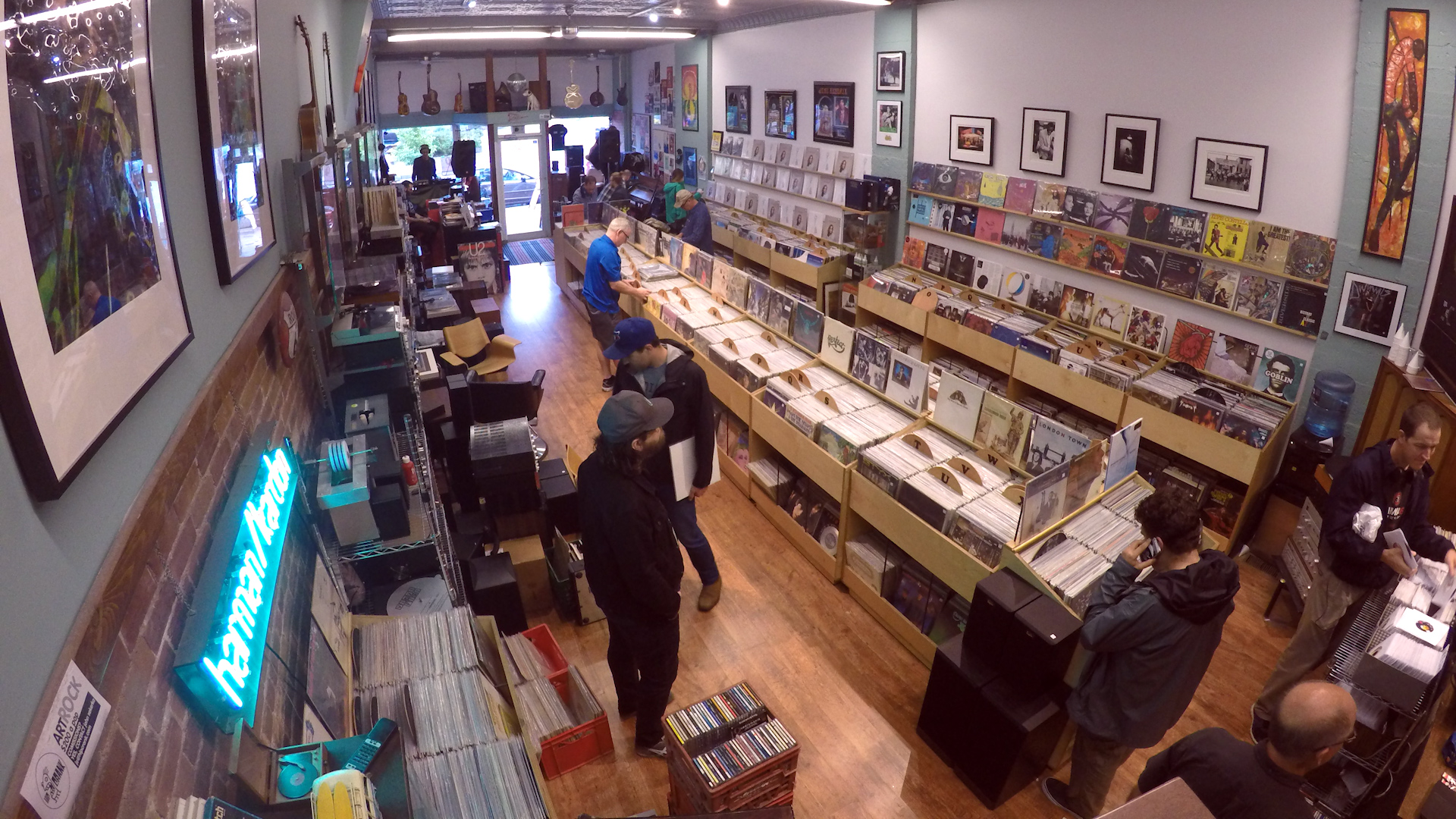 A photo taken from the ceiling camera of a record store. People are browsing